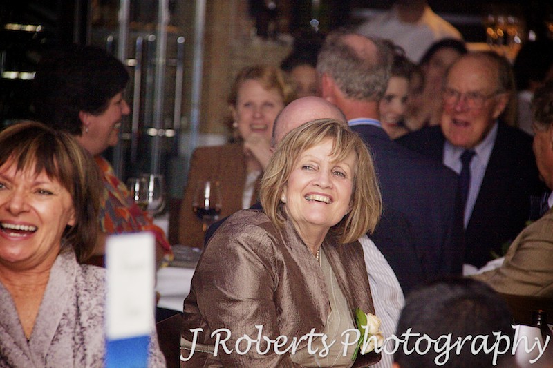 mother of the bride laughing at speeches - wedding photography sydney